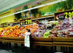 A photo of fruits and vegetables in a supermarket. 